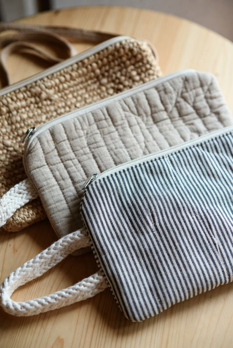 Fabric pouches stacked in a wardrobe shelf